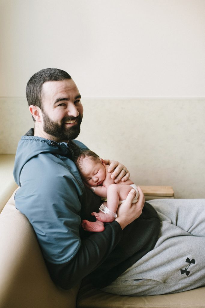 dad holding new baby at hospital