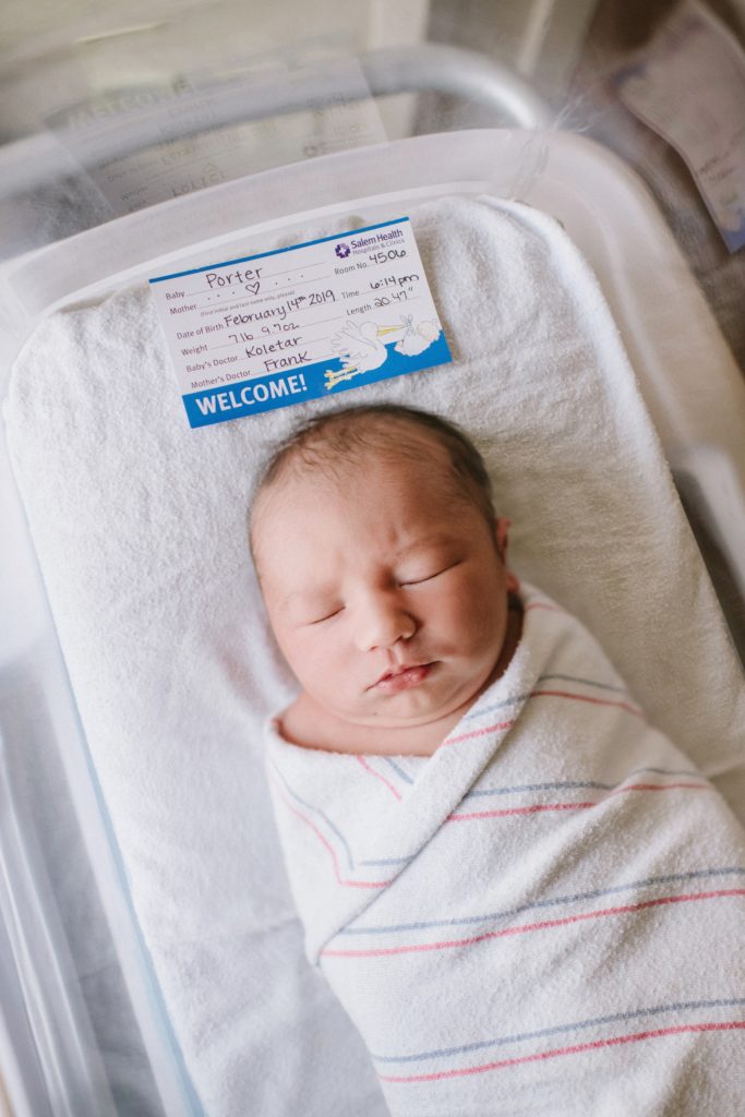newborn baby in hospital basinet