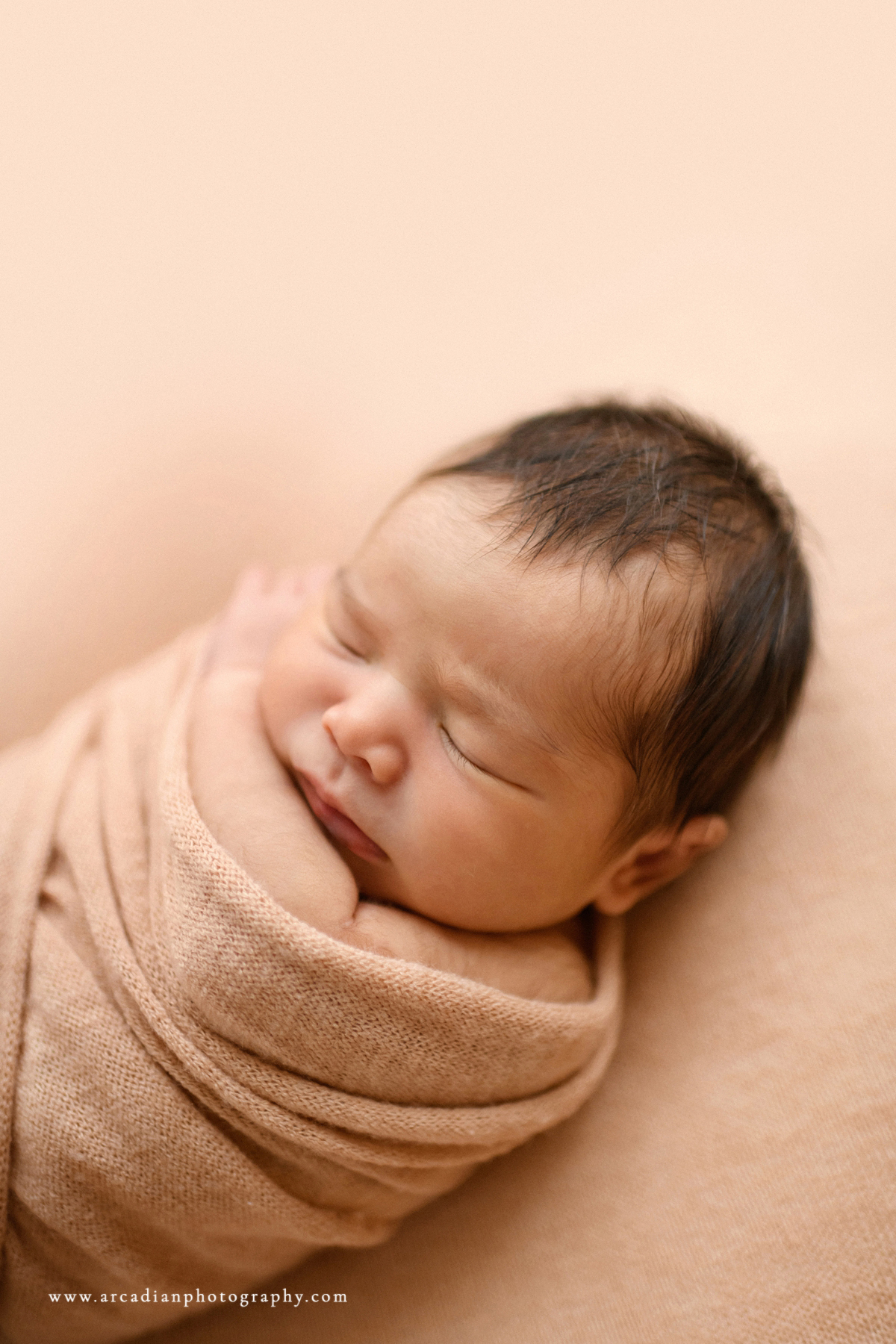 Snug as a bug - learn more about booking newborn photos.