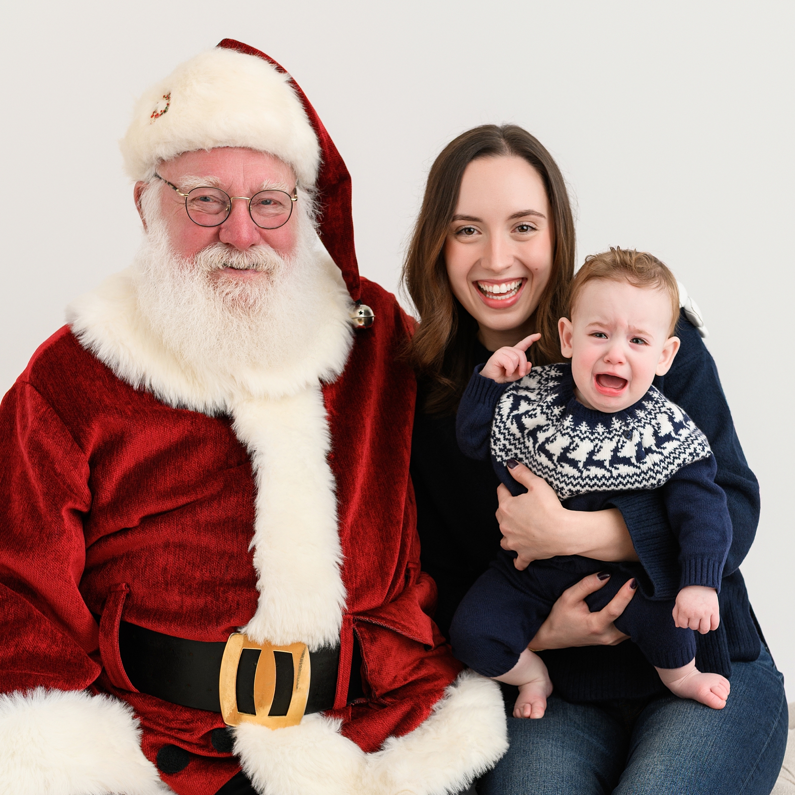Mom and toddler wearing cozy coordinating outfits for Santa photos.